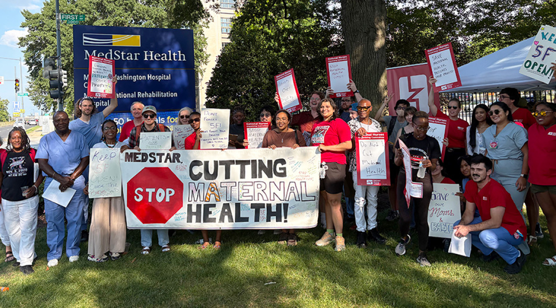 Large group of nurses and community members outside MedStar hospital holding banner "MedStar: Stop Cutting Maternal Health"