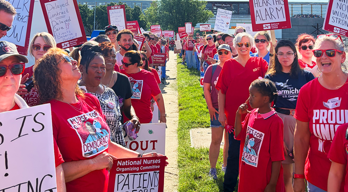 Rows of striking Wichita nurses, holding signs.