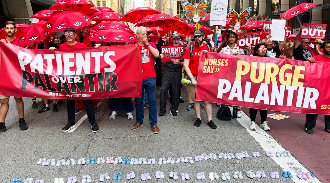 Nurses in streets holding 'Purge Palantir' banners, umbrellas, in front of baby shoes