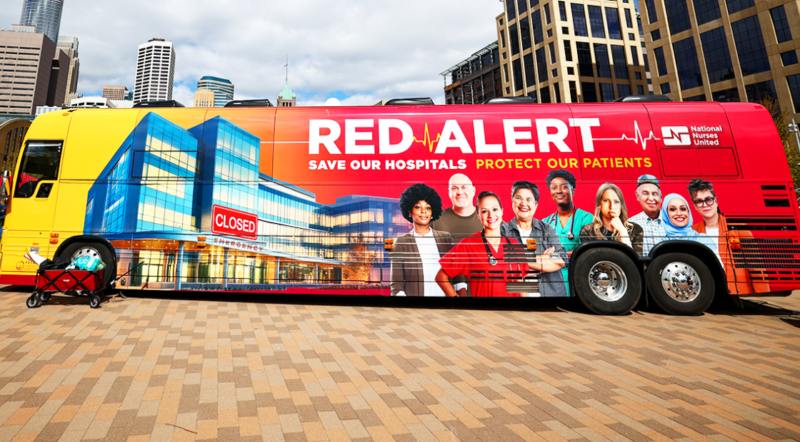 Picture of Red Alert tour bus against city backdrop