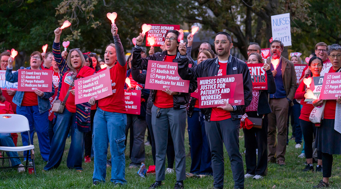 Group of nurses outside, holding lights and signs "Nurses Demand Justice for Patients and Workers Everywhere" and "Count Every Vote"