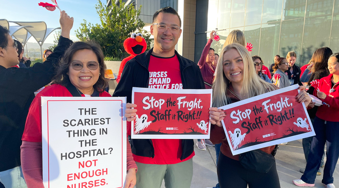 Three nurses outside smiling, holding signs "Stop the Fright, Staff it Right"