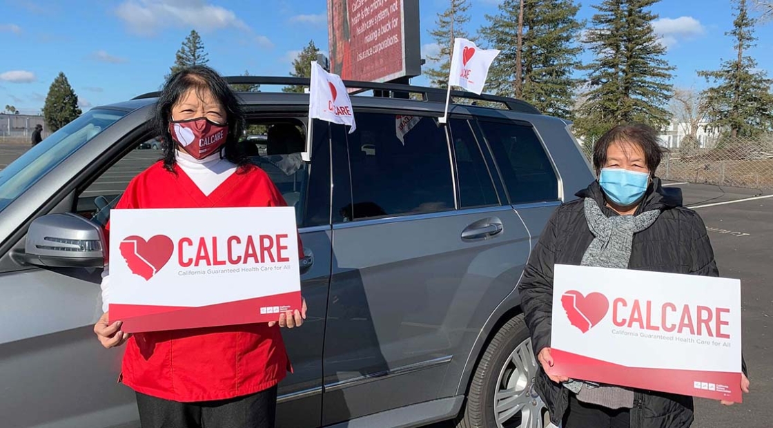 Nurses outside hold CalCare signs