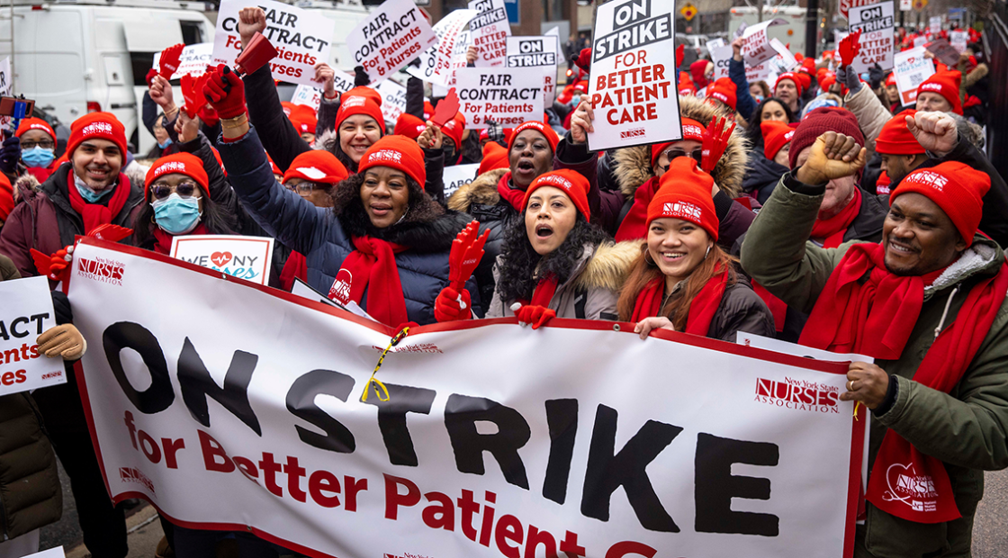 NYSNA nurses marching with signs and banners "On strike for better patient care"