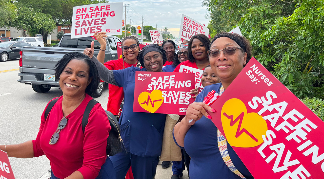 Nurses outside holding signs "Safe Staffing Saves Lives"