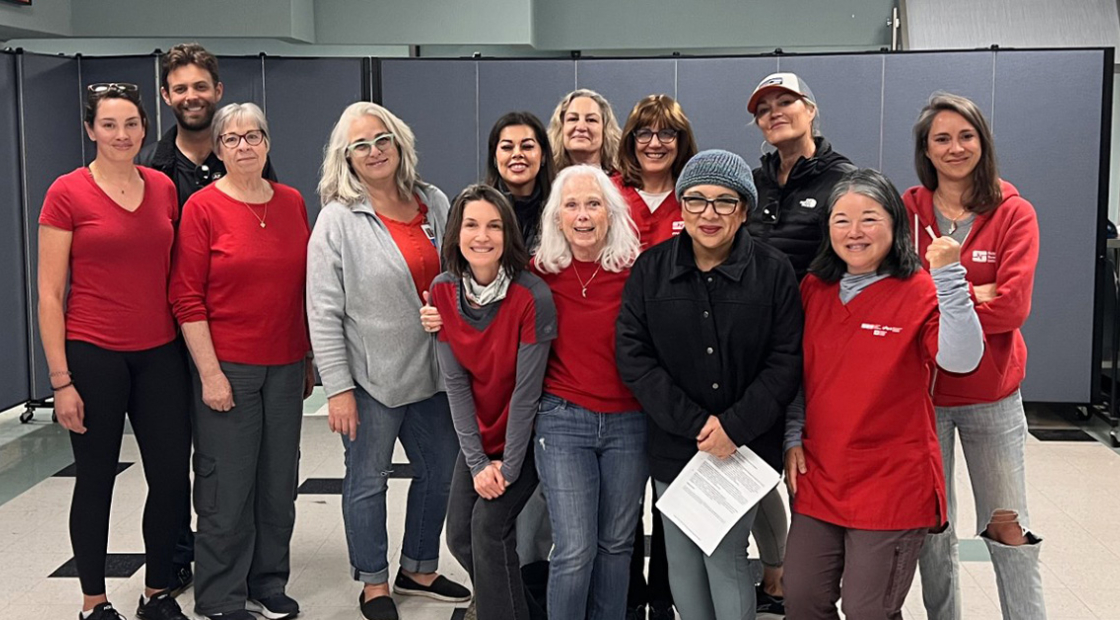 Large group of nurses inside hospital, smiling