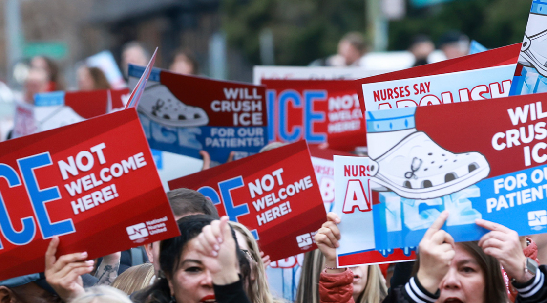Marching hands holding signs "ICE Not Welcome Here" and "Will crush ICE for our patients"