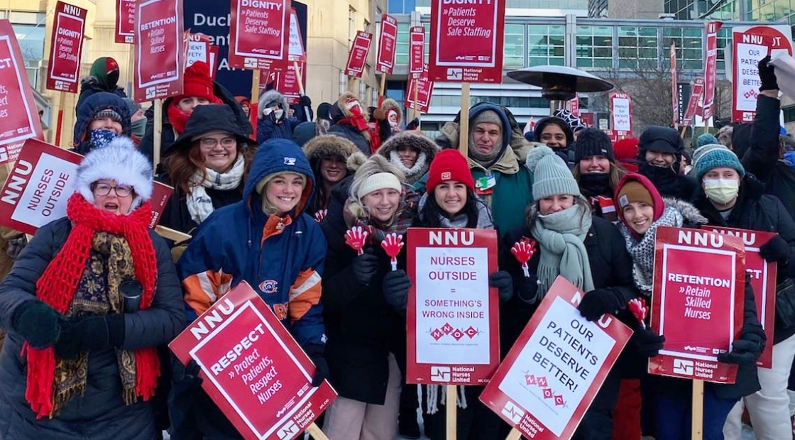 UChicago nurses gather with signs in support of safe staffing.