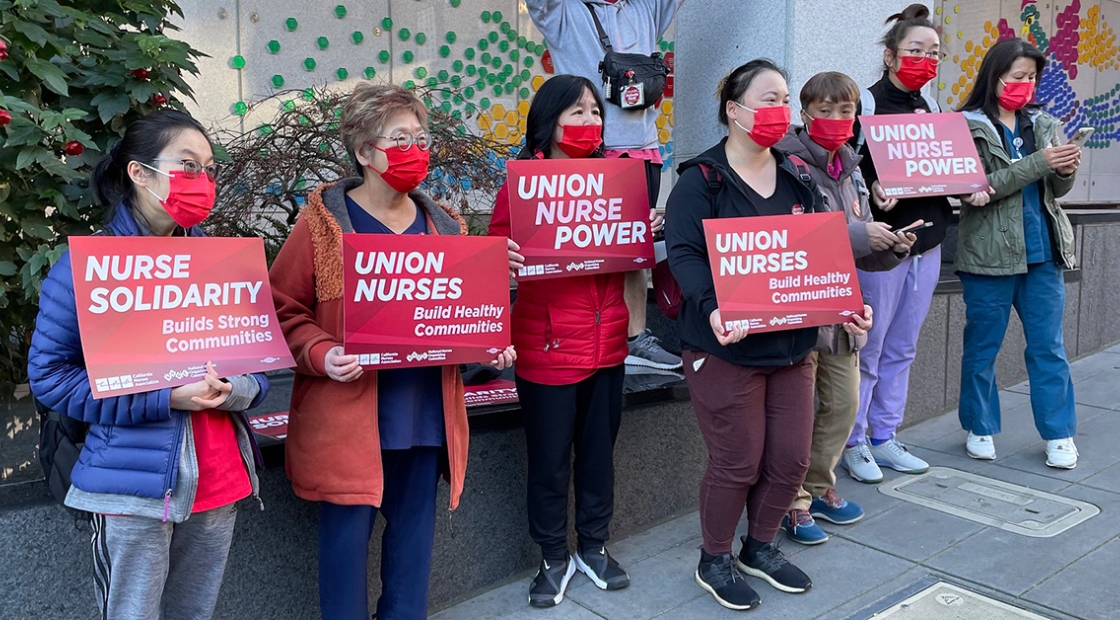 Nurses holding signs "Union Nurse Power"