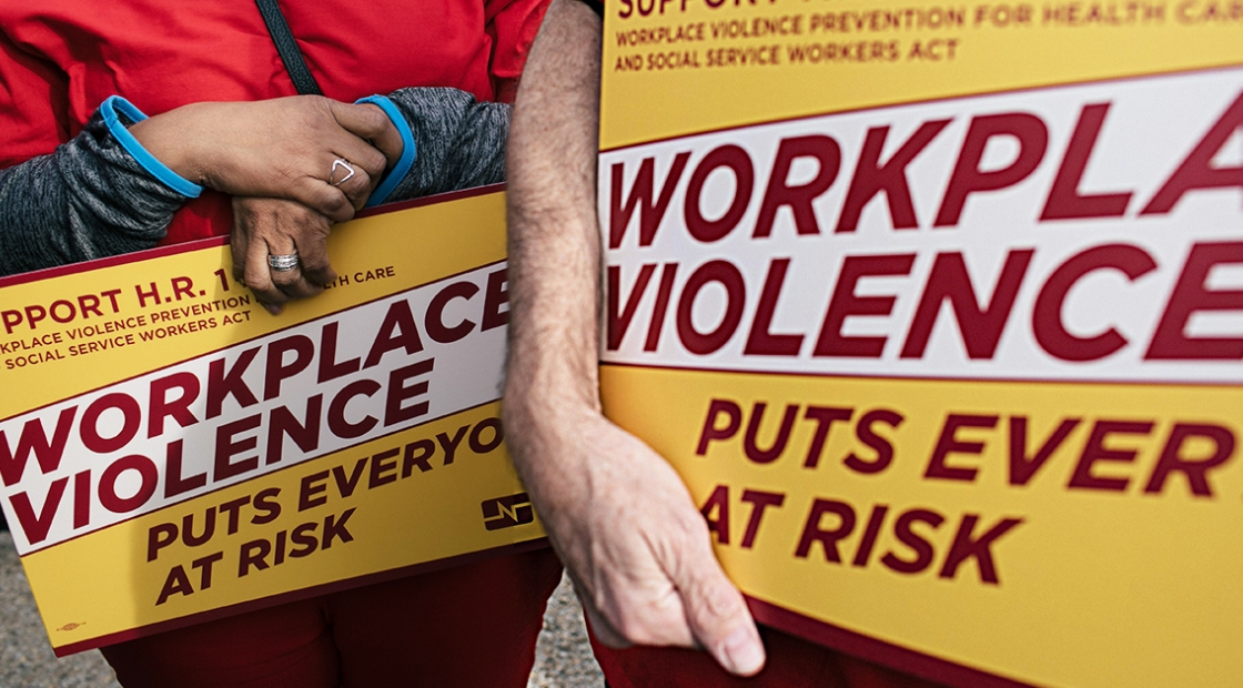 Nurses holding signs "Workplace Violence Puts Everyone at Risk"