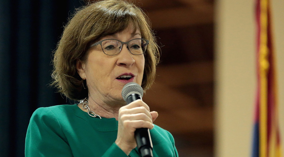 Susan Collins holding microphone