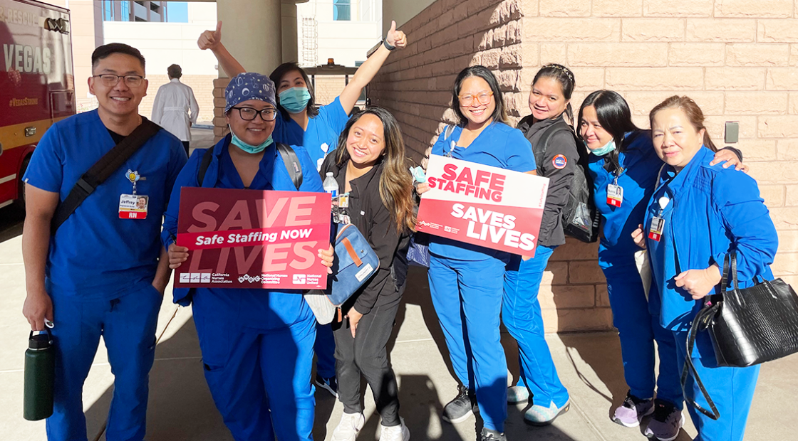 MountainView hospital nurses holding signs "Safe staffing. Save lives." and "Save lives. Safe staffing NOW."