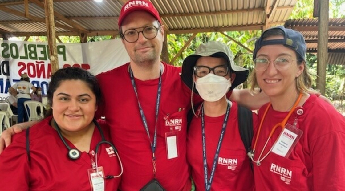 Four nurses in red scrubs in rural area of Guatemala 