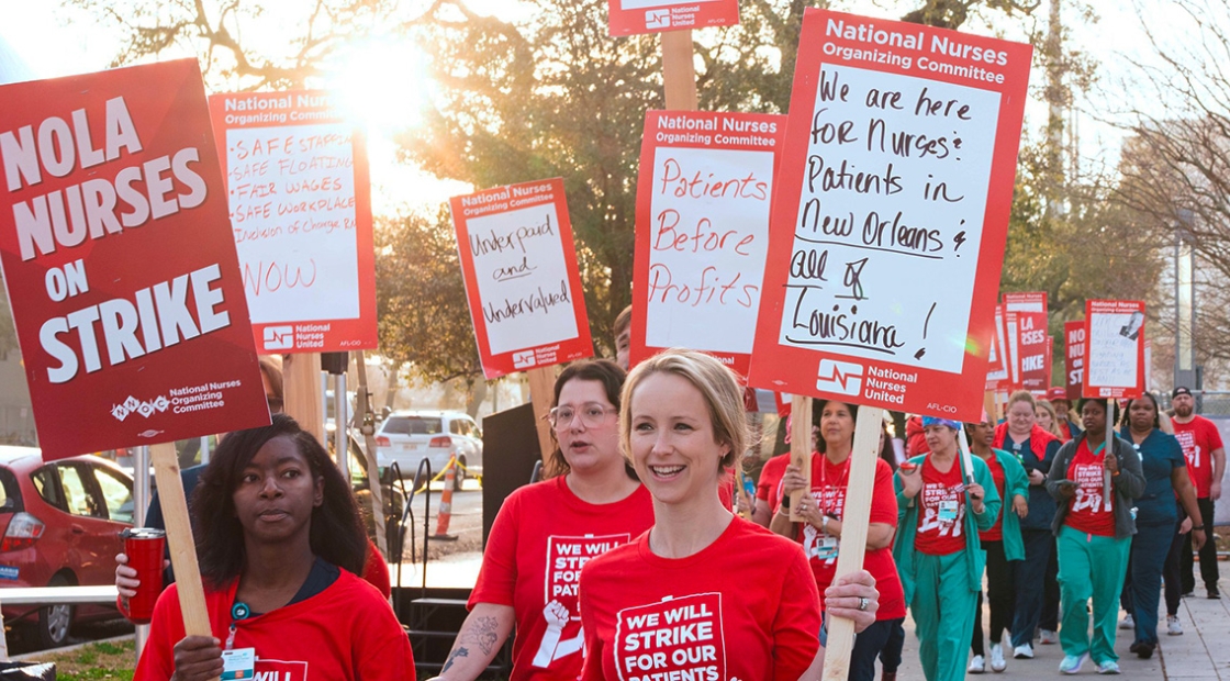 Nurses on picket line holding signs supporting patient safety and need