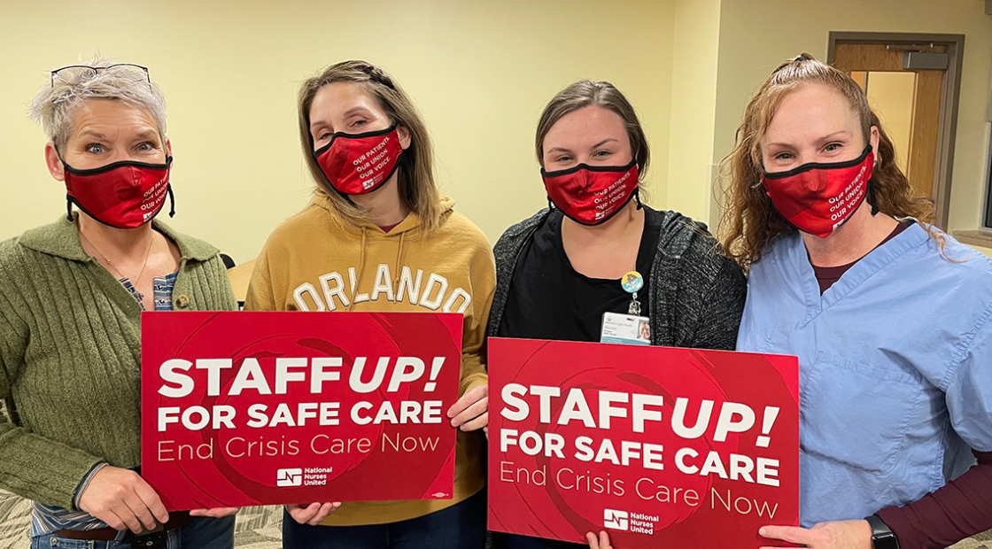 Four nurses inside hold signs "Staff Up for Safe Care"