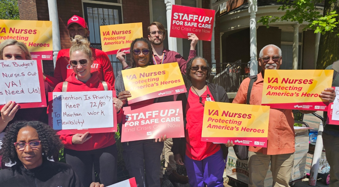 Nurses outside holding signs "VA Nurses: Protecting America's Heroes"