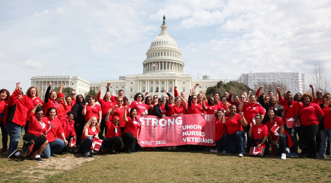 VA nurses pose with signs at the capitol in rally for workers' rights