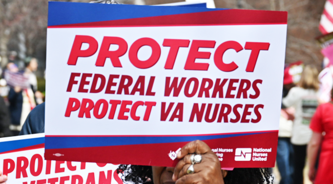 Nurse holding sign "Protect federal workers. Protect VA nurses"