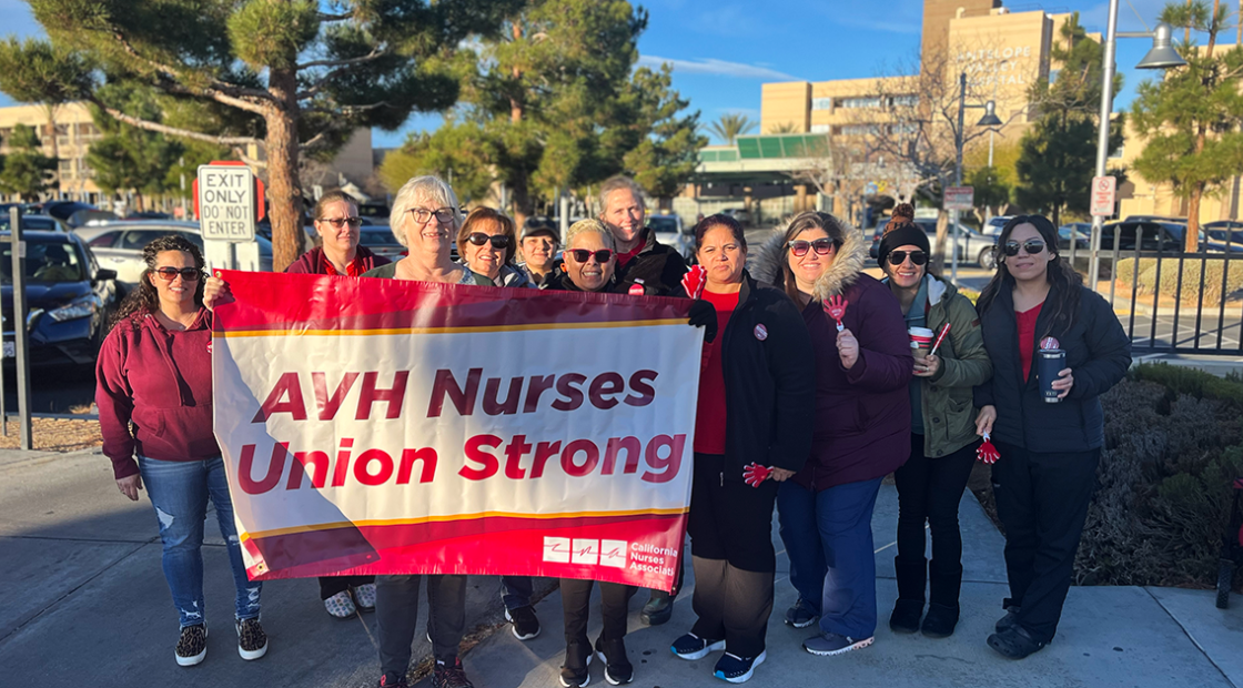 AVH nurses pose with banner that reads "AVH union strong."