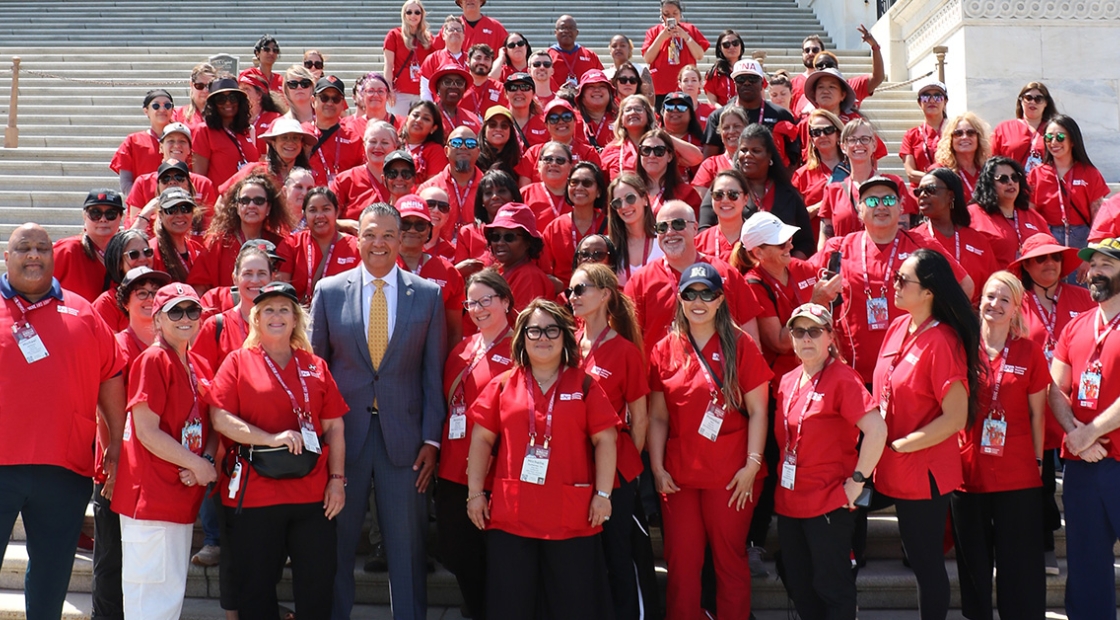 Nurses stand on D.C. Capitol steps with Senator Padilla
