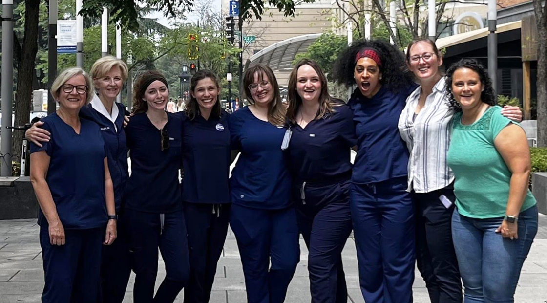 Group of nurses arm-in-arm outside