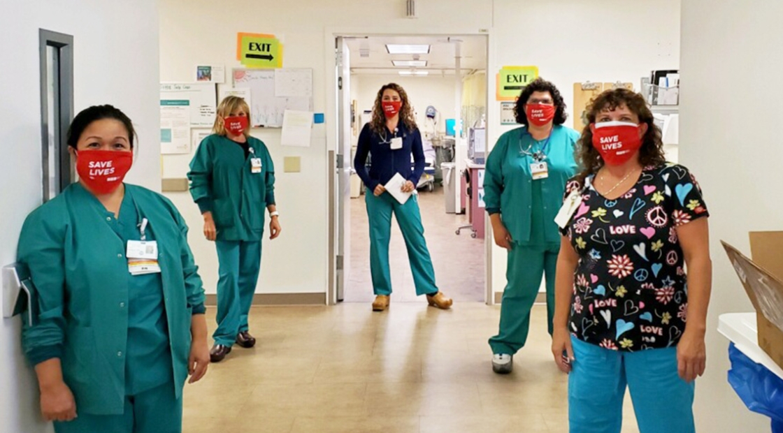 Five nurses in hospital hallway