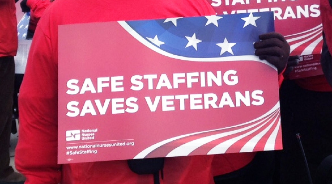 Hands hold sign "Safe Staffing Saves Veterans"