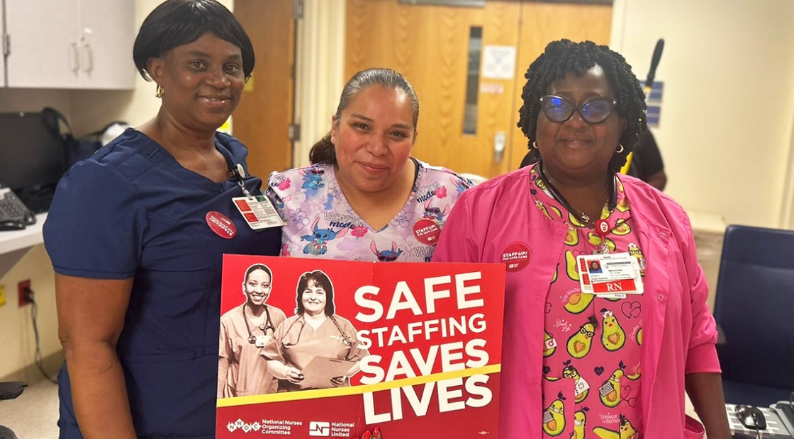 Group of three nurses inside hospital, one hold sign "Saf Staffing Saves Lives"