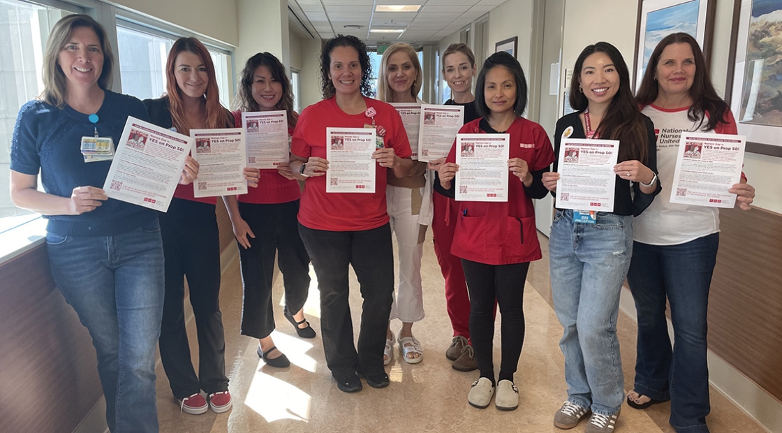 San Diego nurses hold flyers in support of prop. 50