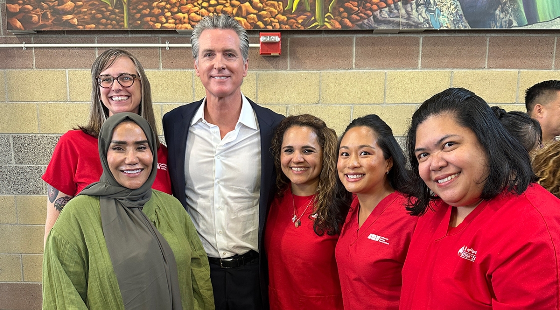 Five nurses standing with Governor Gavin Newsom