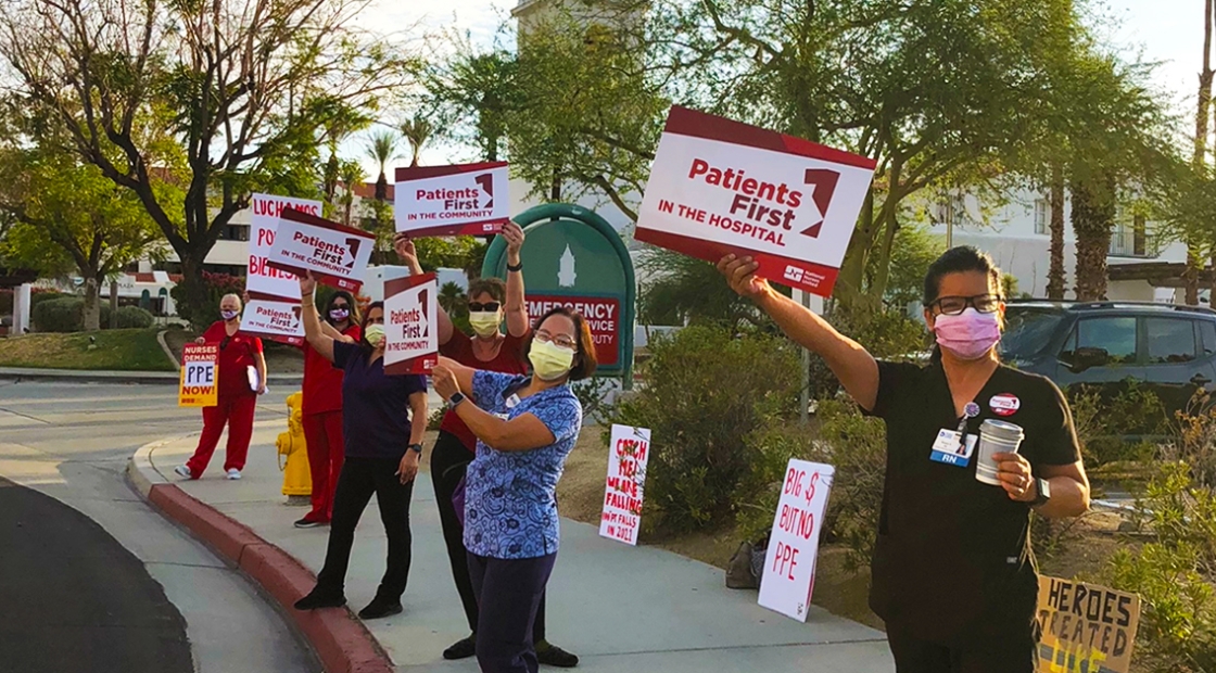 Nurses outside holding signs "Patients First in the Hospital"