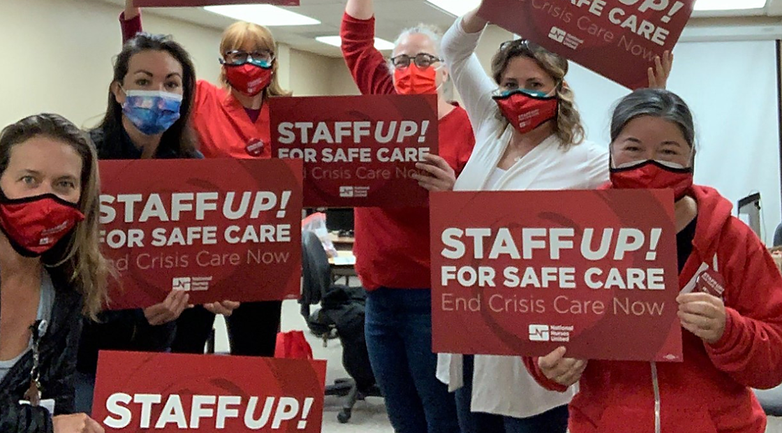 Watsonville nurses holding signs "Staff UP for safe care. End Crisis Care Now"