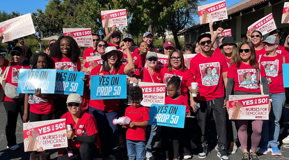 Nurses holding signs "Yes on 50: Nurses for Democracy"