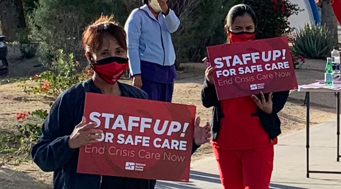 Nurses holding signs "Staff UP for safe care. End Crisis Care Now"