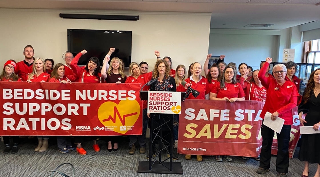 Maine nurses taking action for safe staffing, holding banner that reads "Bedside nurses support ratios!"