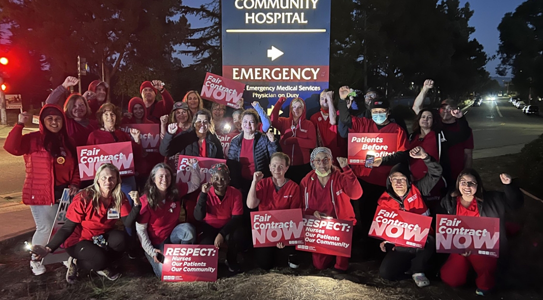 Large groups of nurses outside Watsonville Community Hospital holding signs "Fair Contract Now"