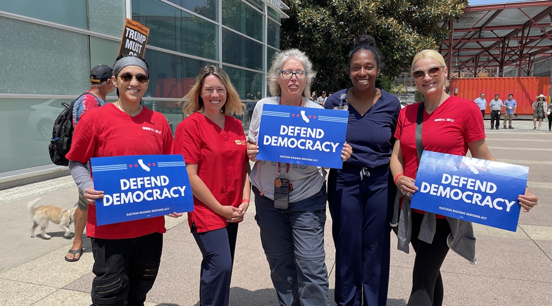 California nurses hold signs that read "Protect Democracy."