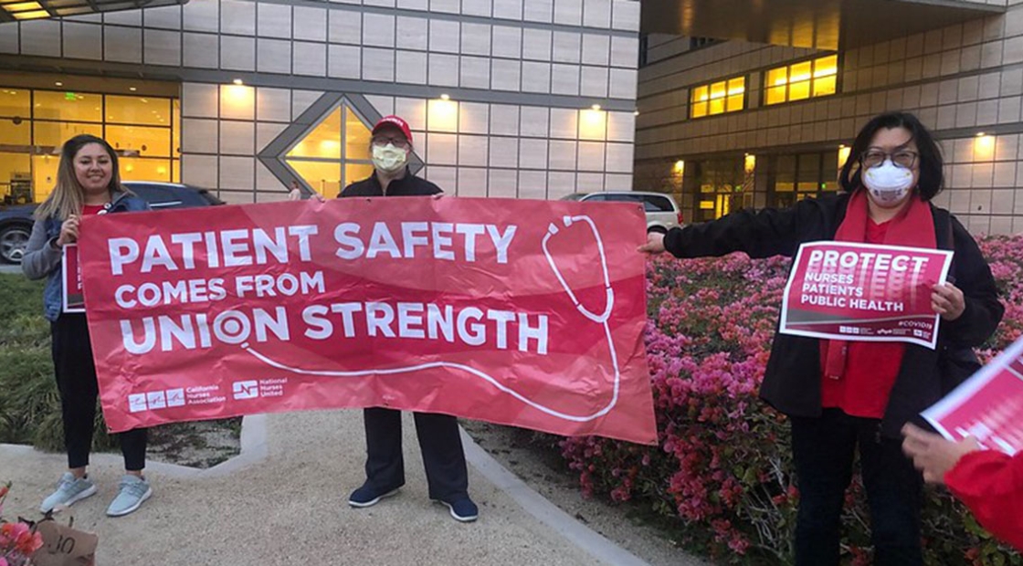 UCSD La Jolla nurses holding banner that reads "Patient safety comes from union strength!"