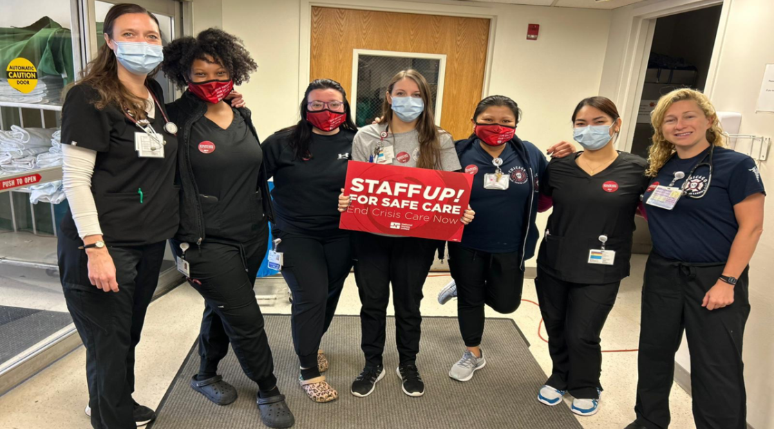 Nurses holding sign that reads "Staff up for safe care!"