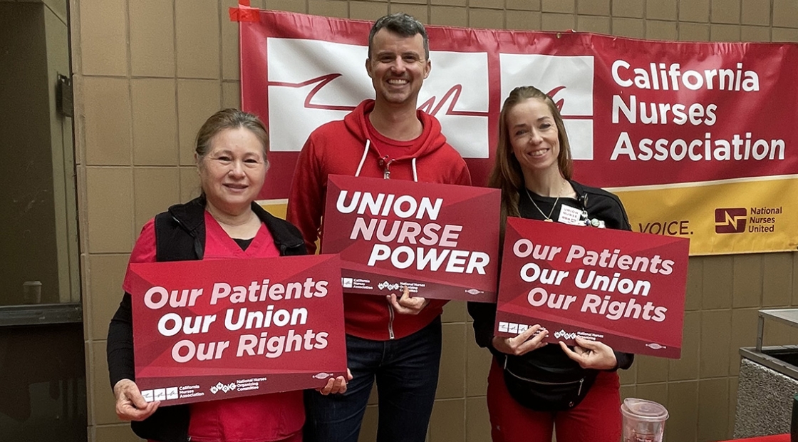 UCSD nurses hold signs in support of union rights and patient safety.