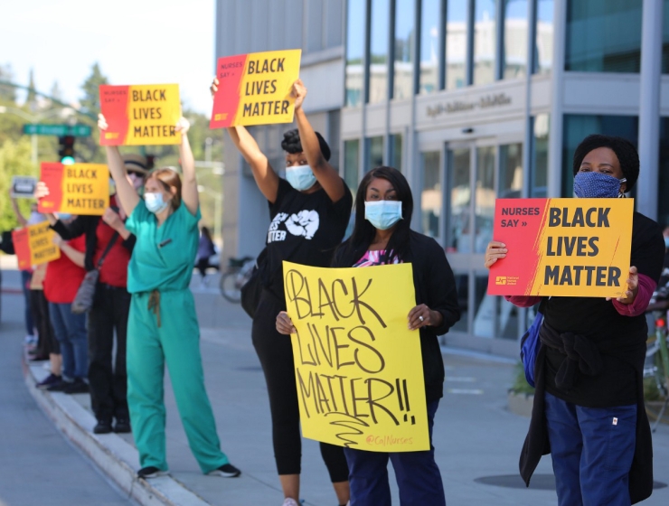 Nurses holdiing "Black Lives Matter" signs