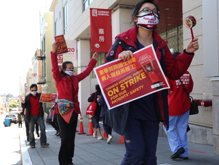 Nurses marching and holding signs: "Chinese hospital nurses on strike for our patients' safety"