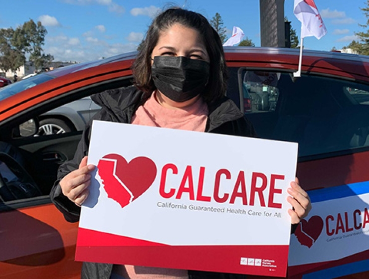 Person holding CalCare sign