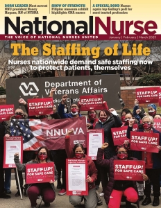Large group of nurses outside hospital hold signs for saf staffing