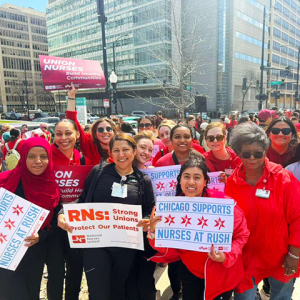 Group of nurses outside, smiling, holdinhg signs "Chicago Supports Nurses at Rush"