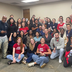 Large group of nurses inside hospital meeting room smiling