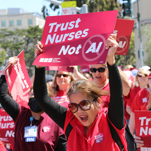 Nurses marching, holding signs "Trust Nurses Not A.I."