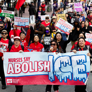 Nurses marching with Abolish ICE banners and signs.