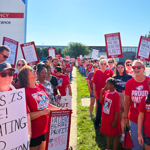 Rows of striking Wichita nurses, holding signs.