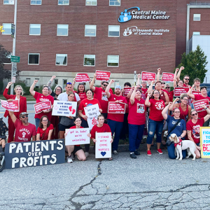 Cental Maine Medical Center nurses raising fists and holding signs "Prime RNs united for our patients."